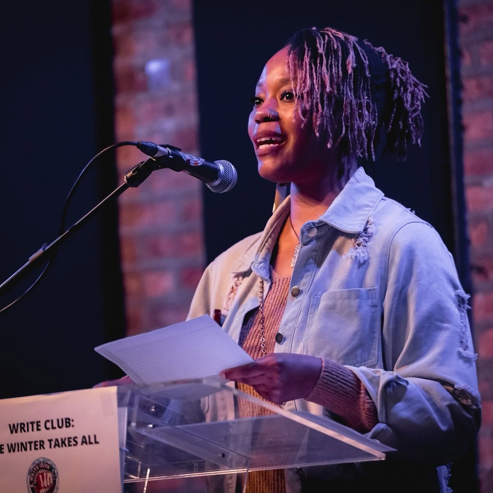Chiquita Renee, Founder and CEO of Yail's Garden, speaking at a podium.